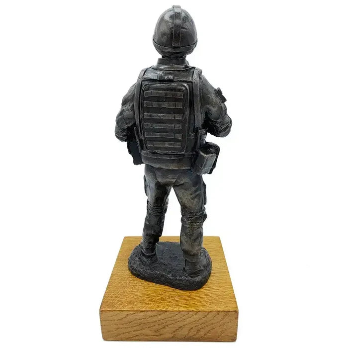 Rear view of British Standing Combat Patrol Bronze Statue highlighting backpack and body armor details, mounted on oak base.  from  John Bull Clothing
