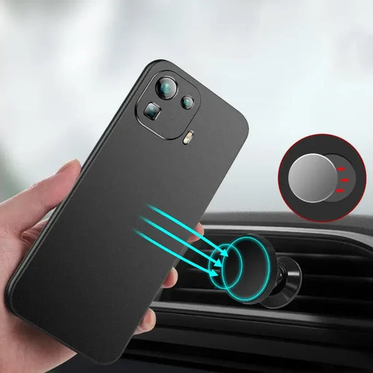 a hand holding a phone with a car air vent