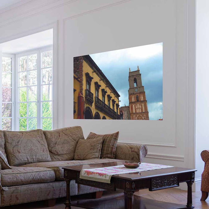 60 inch Mexican cathedral tower and building against a blue sky wall decal installed on wall in a living room
