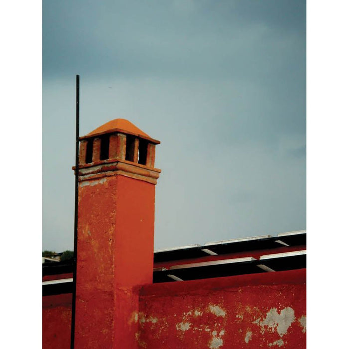 Red brick Mexican chimney against a gray sky wall decal | Wallhogs