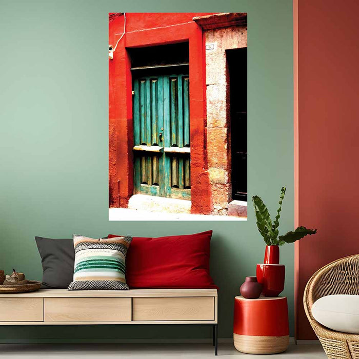 48 inch decal of a red frame with green door of a Mexican home installed on a wall above a bench with pillows