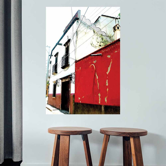 48 inch red and white Mexican House Architecture poster displayed on wall above two wooden stools