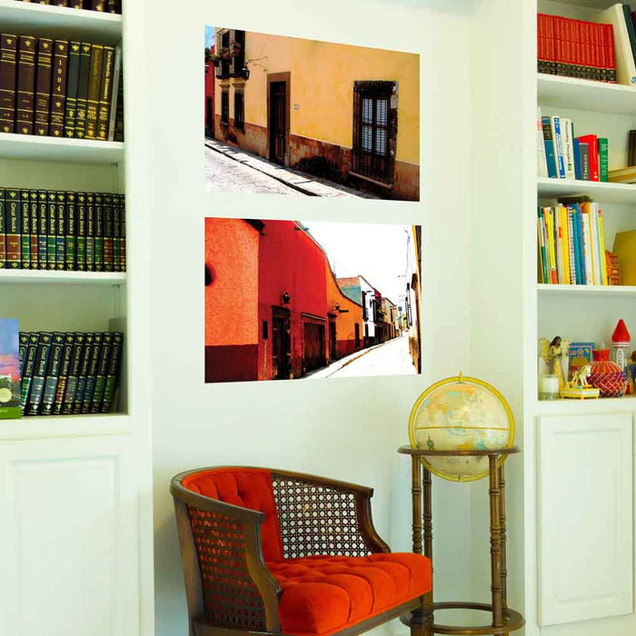 24 inch poster Mexican street and yellow house architecture displayed on wall above chair and globe