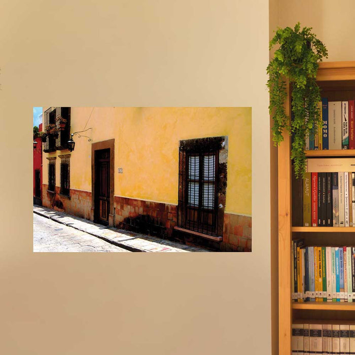 36 inch Mexican street and yellow home architecture decal installed on a wall next to bookcase