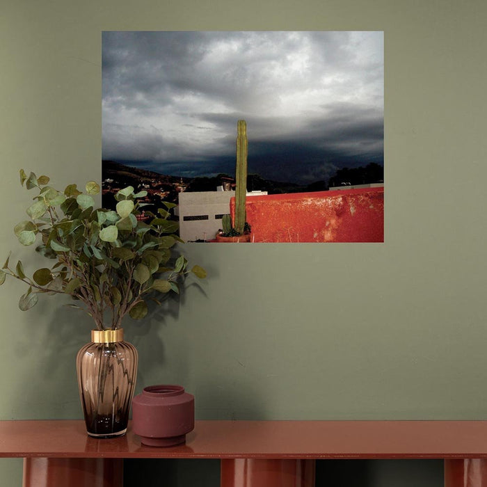 36 inch decal of a dark stormy sky in Mexican with cactus in foreground installed on wall above console table