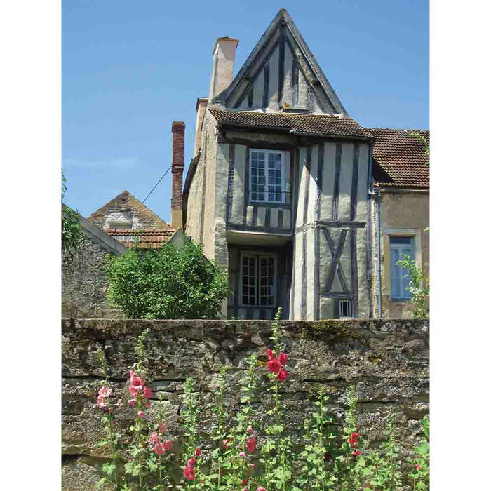 Traditional half-timbered house in Noyers, France with wall with flowers in the foreground wall decal printed | Wallhogs