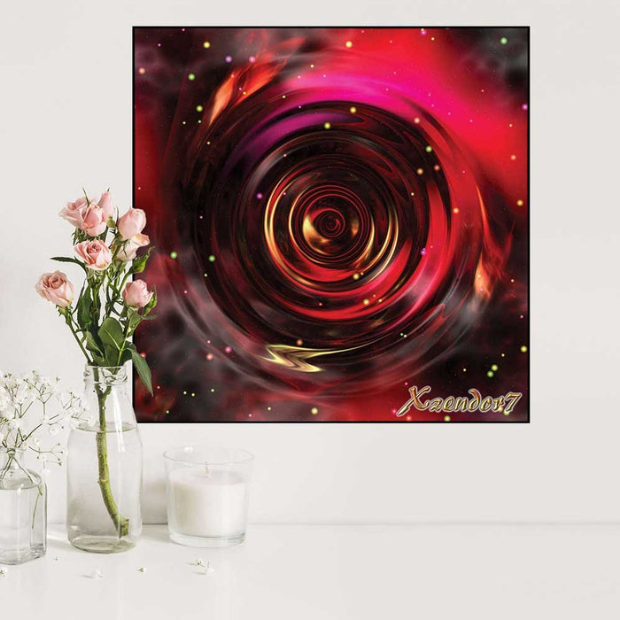 24 inch poster of an abstract red, gold  and black space vortex spiral gloss poster displayed on a white wall with flowers and a candle below.